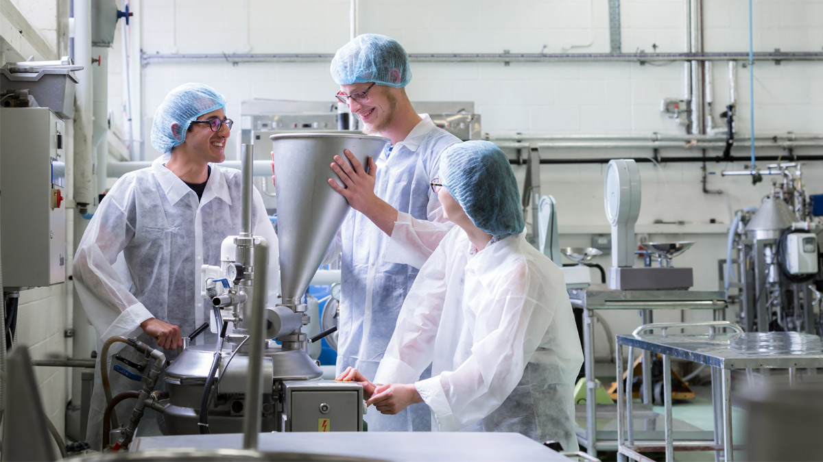 Three students working in a laboratory