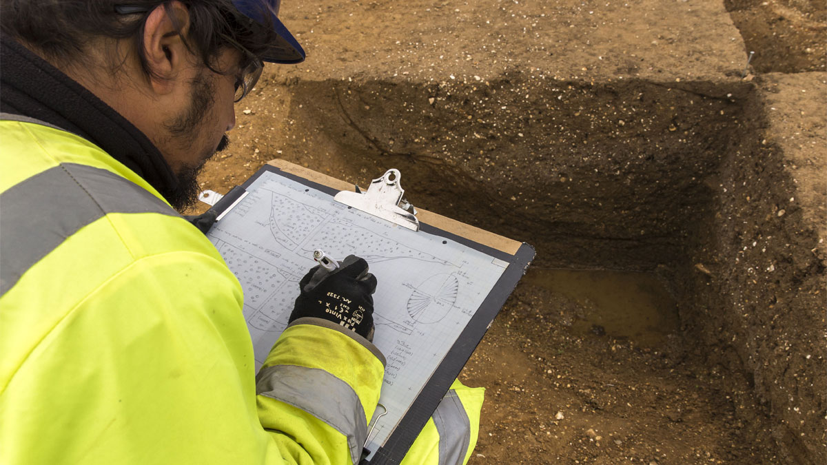 Archaeologist writing a report