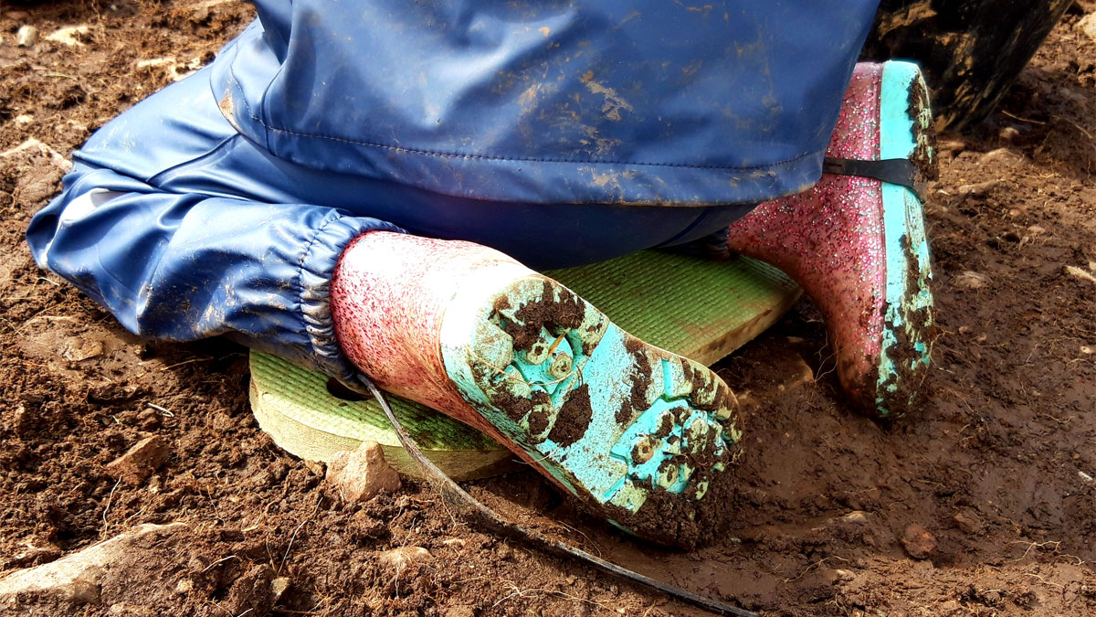 Muddy wellies while digging
