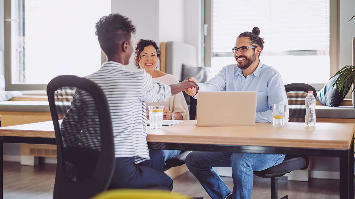 Two students shaking hands