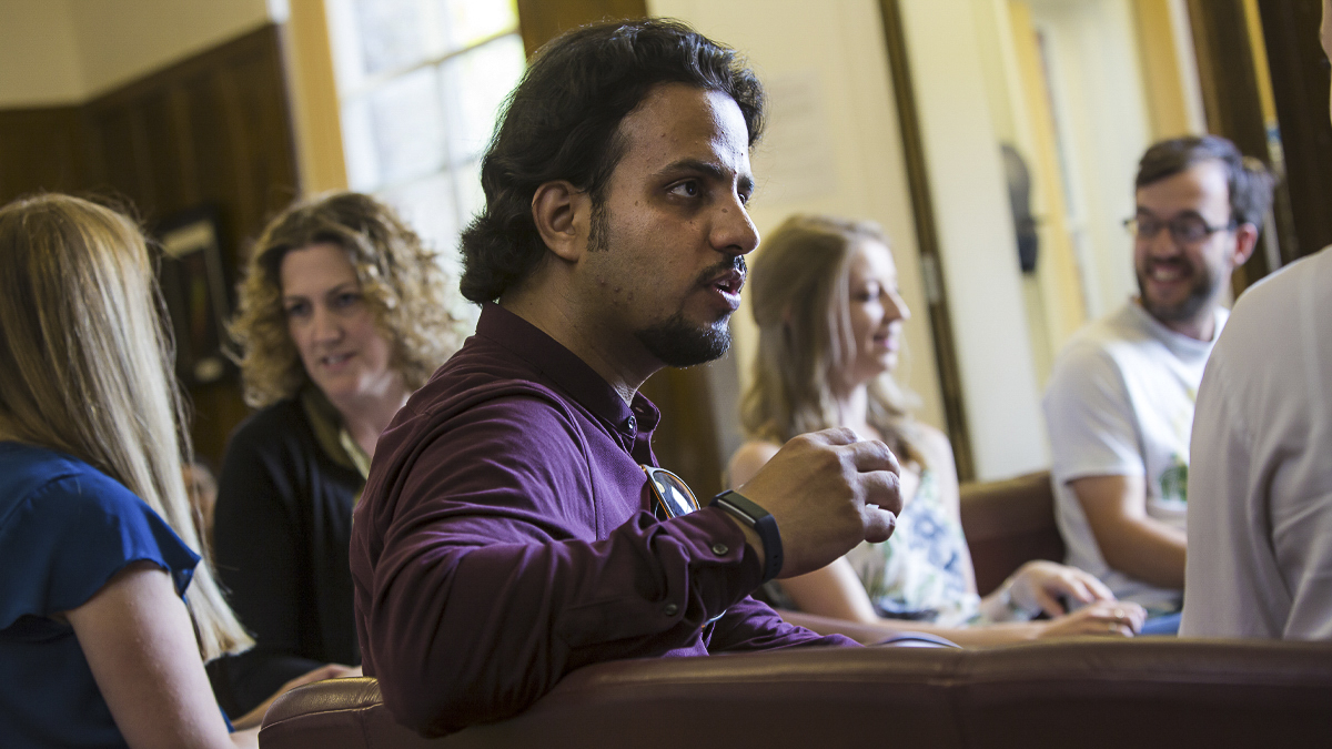 PhD students socialising round a table