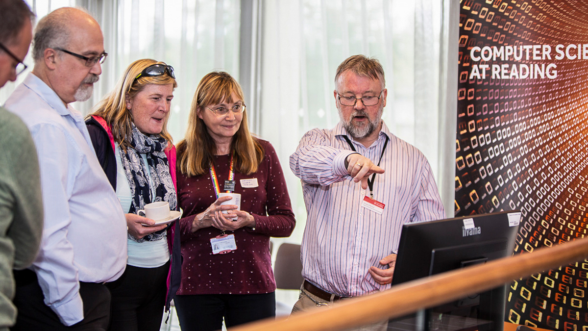 Staff from the Department of Computer Science looking at a computer screen