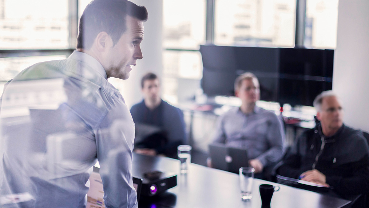 Four people in an office presentation