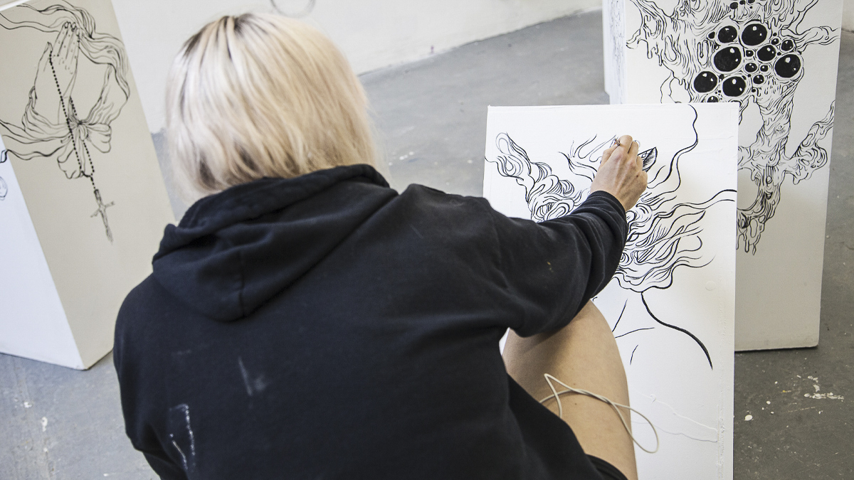 Student, Laura Nicholson, working on her artwork